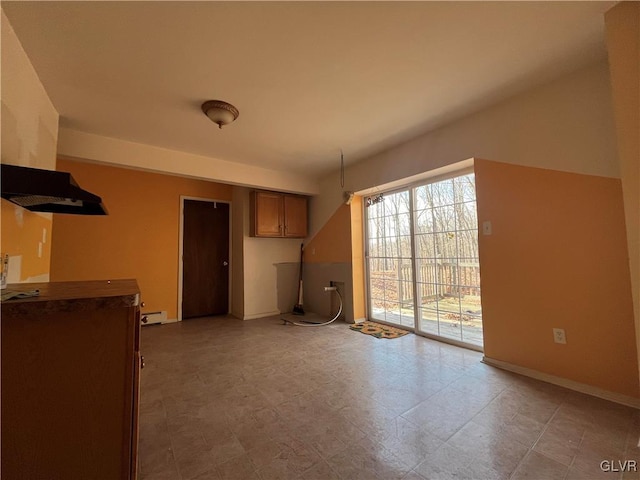 unfurnished living room featuring baseboards and a baseboard radiator