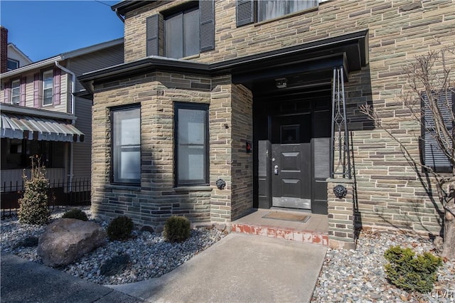 entrance to property with stone siding