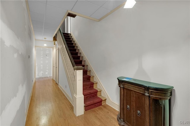 staircase with baseboards and wood finished floors