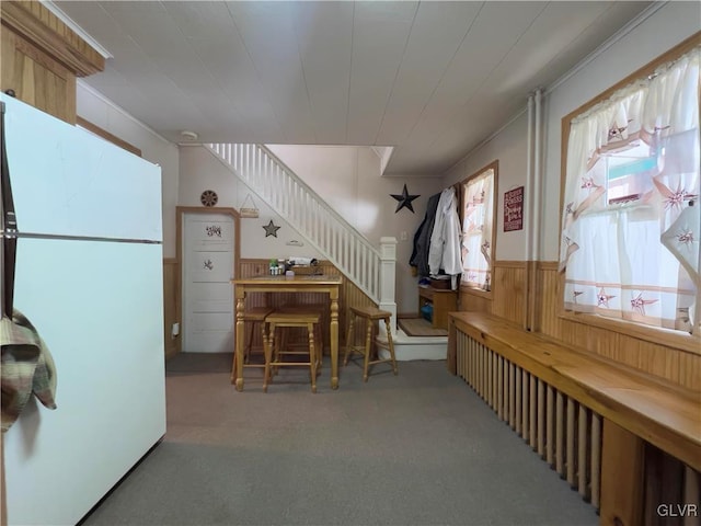 interior space with stairway, wainscoting, and carpet