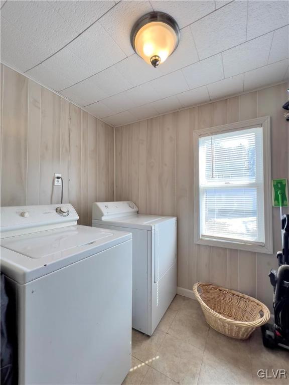 laundry area featuring light tile patterned flooring, laundry area, and washing machine and dryer