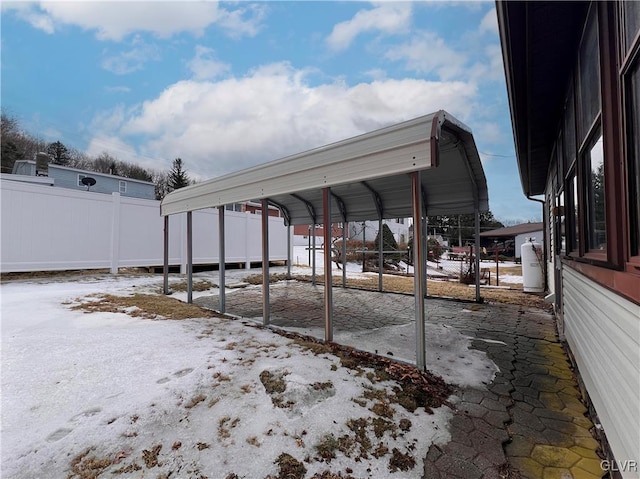 exterior space featuring a detached carport and fence