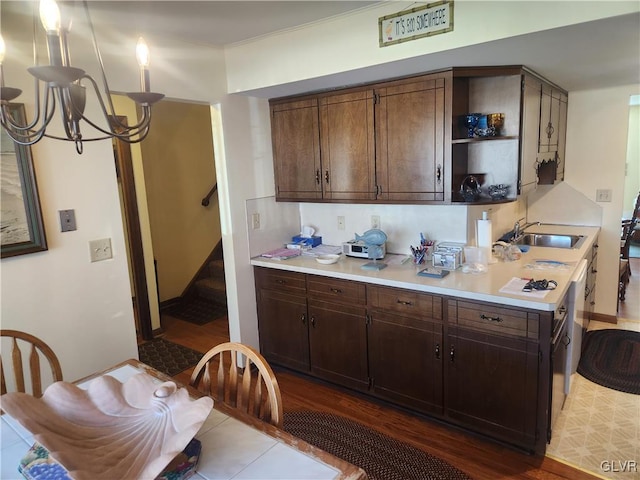 kitchen featuring dark wood-type flooring, a sink, open shelves, light countertops, and dark brown cabinets