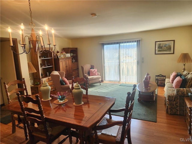 dining space featuring a notable chandelier and wood finished floors