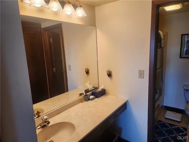 full bath featuring a shower, baseboards, toilet, and vanity