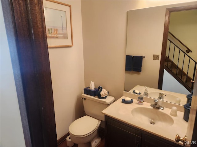 bathroom featuring toilet and vanity