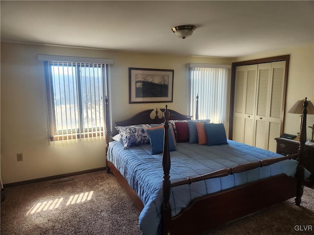 bedroom with carpet flooring, baseboards, and a closet