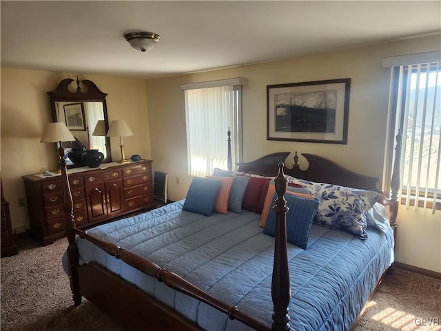 carpeted bedroom featuring baseboards