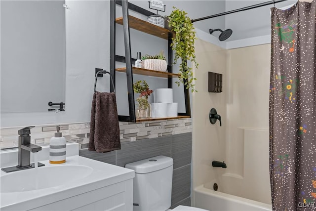 full bathroom with vanity, toilet, tile walls, and shower / tub combo