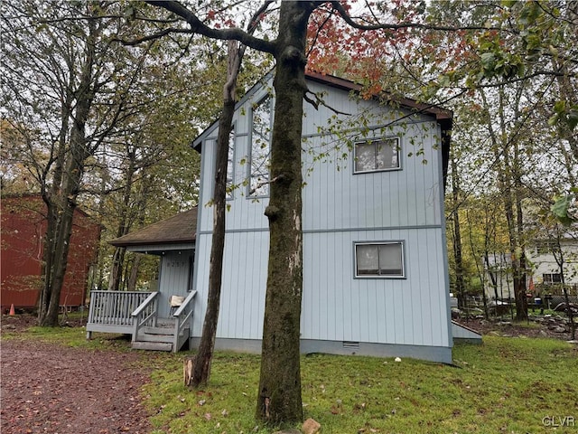 view of home's exterior featuring crawl space and a lawn