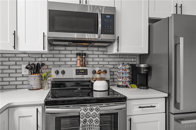 kitchen featuring tasteful backsplash, white cabinets, and stainless steel appliances