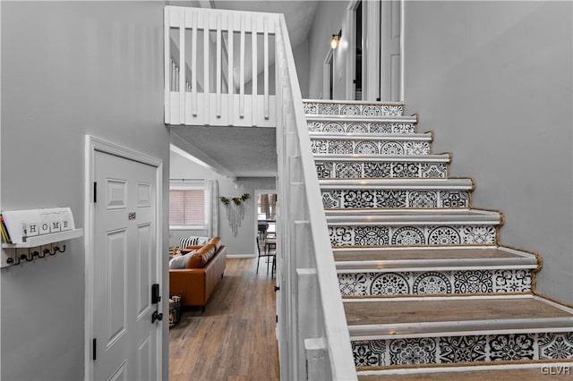 stairs featuring wood finished floors