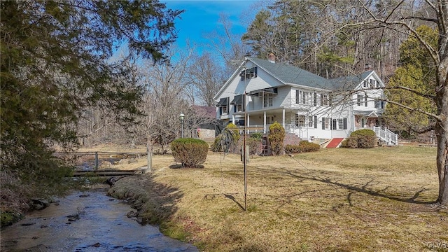 rear view of house with a lawn