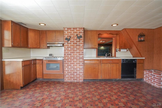 kitchen featuring a sink, light countertops, black dishwasher, wall oven, and under cabinet range hood