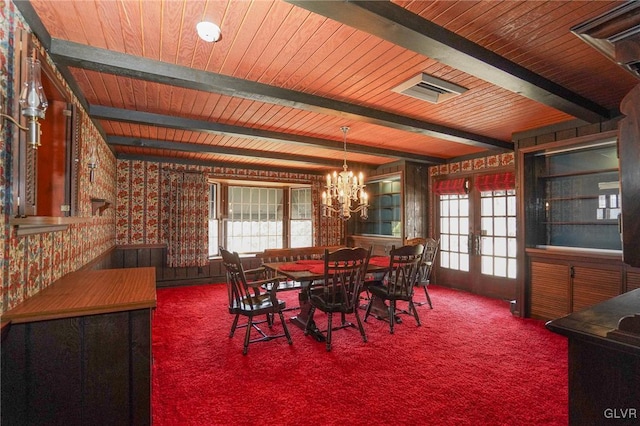 dining area with beamed ceiling, plenty of natural light, wallpapered walls, and carpet