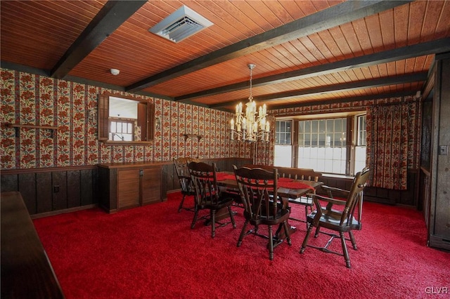 dining area featuring visible vents, beamed ceiling, carpet floors, an inviting chandelier, and wallpapered walls