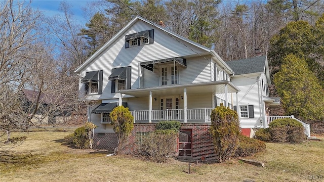 view of front of property with a porch, stairway, and a front yard