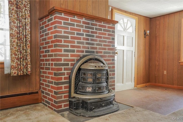 interior details with wooden walls, baseboards, a wood stove, and concrete flooring