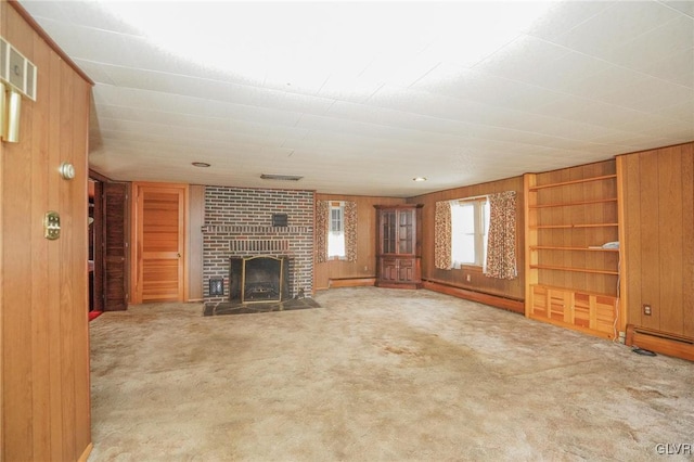 unfurnished living room with wooden walls, carpet, and a baseboard radiator