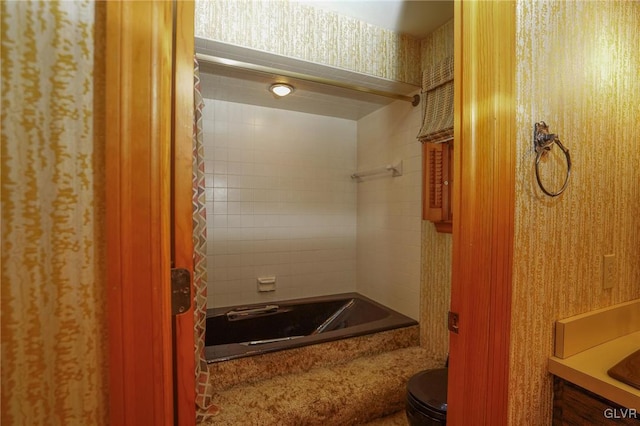 bathroom featuring toilet, wallpapered walls, and washtub / shower combination