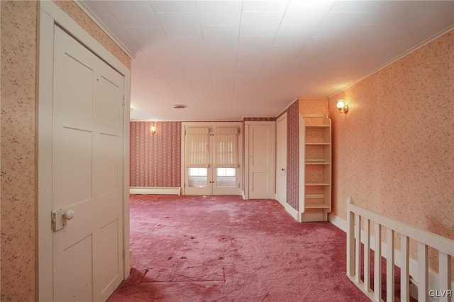 hallway featuring french doors, carpet floors, baseboards, and wallpapered walls