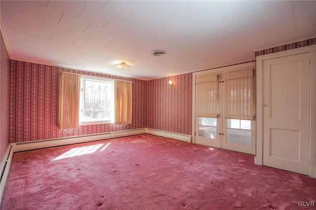 carpeted empty room featuring visible vents, french doors, wallpapered walls, and baseboards