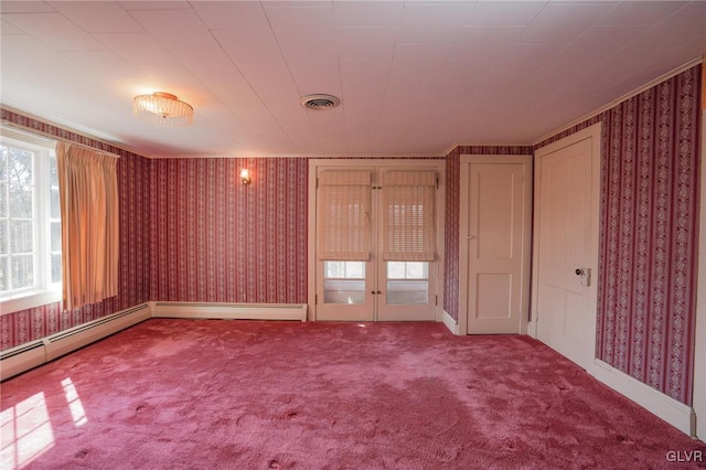 carpeted empty room featuring visible vents, french doors, and wallpapered walls