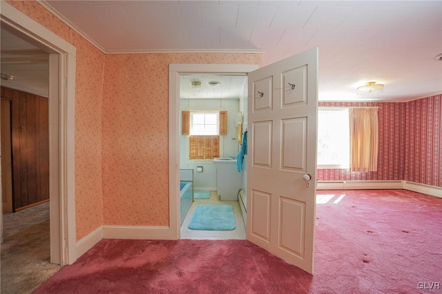 corridor featuring baseboards, crown molding, carpet flooring, and wallpapered walls