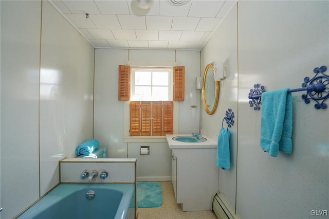 bathroom with vanity, a bath, and baseboard heating