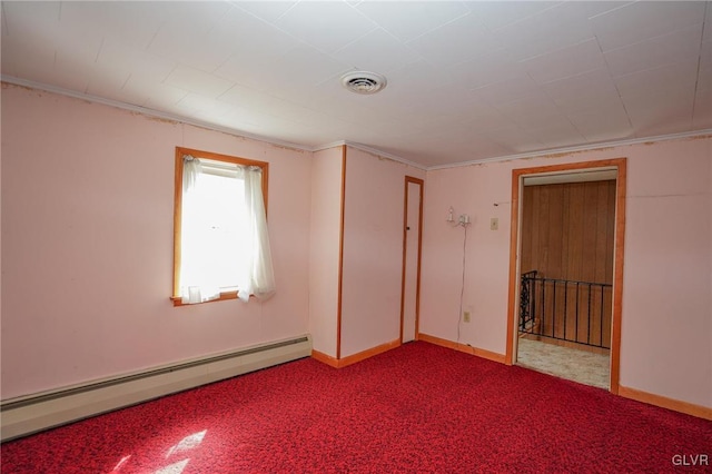 unfurnished room featuring visible vents, baseboards, baseboard heating, and carpet flooring