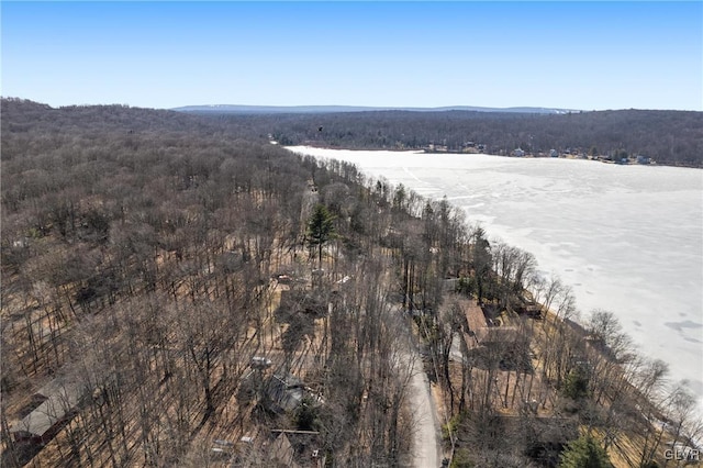 birds eye view of property featuring a view of trees