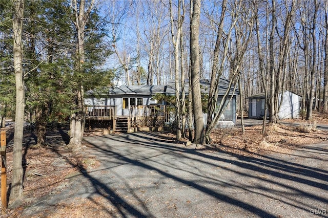 view of front of house featuring a deck and driveway