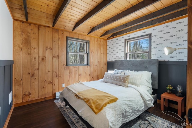 bedroom with beamed ceiling, wood ceiling, baseboards, and wood finished floors