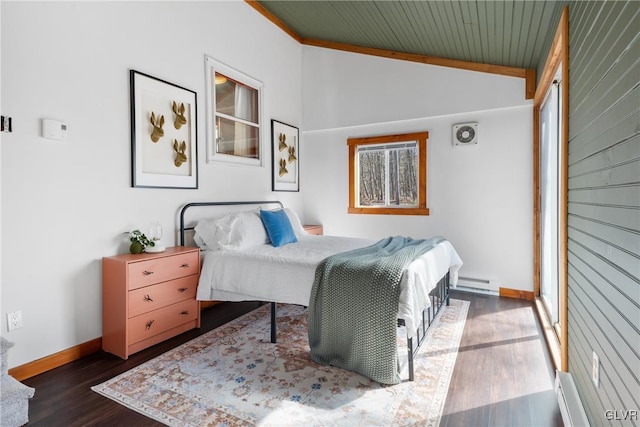 bedroom with wood finished floors, baseboards, a baseboard radiator, vaulted ceiling, and baseboard heating