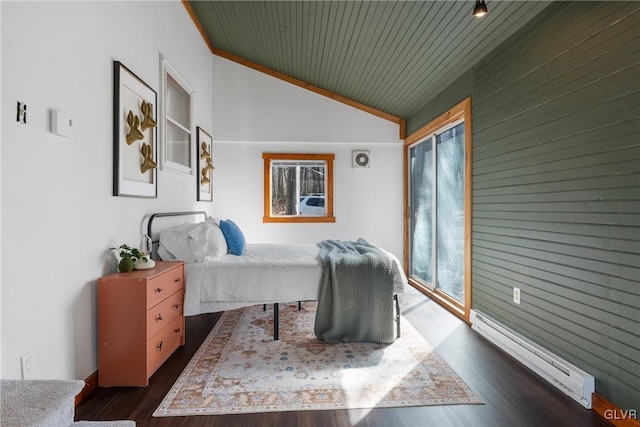 bedroom with dark wood-style floors, baseboard heating, and vaulted ceiling