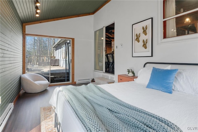 bedroom featuring a baseboard radiator, lofted ceiling, baseboard heating, wood finished floors, and access to outside