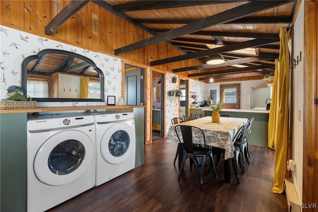 clothes washing area with wood finished floors, wallpapered walls, wood ceiling, laundry area, and washing machine and clothes dryer