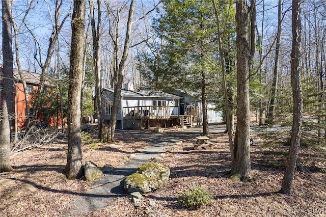 rear view of house with a wooden deck