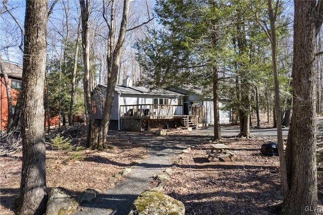 rear view of property featuring a deck