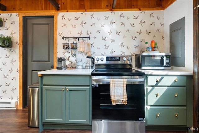 kitchen with green cabinets, light countertops, wallpapered walls, and stainless steel appliances