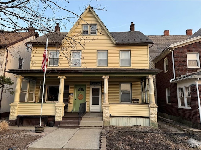 view of front of property featuring a porch and a chimney