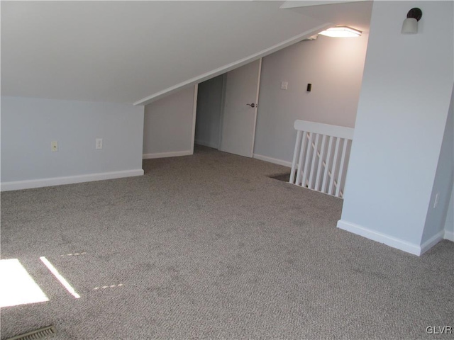 bonus room with lofted ceiling, baseboards, and carpet floors