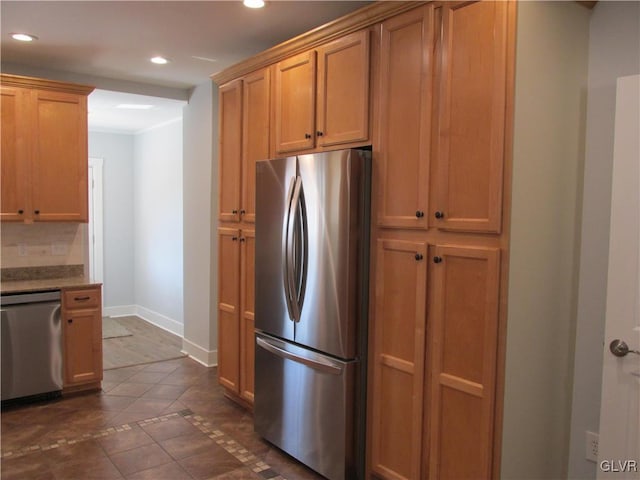 kitchen featuring baseboards, decorative backsplash, recessed lighting, stainless steel appliances, and dark tile patterned flooring