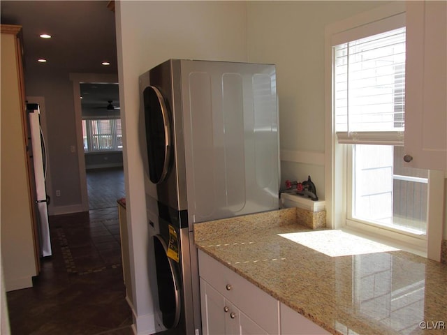 bathroom with recessed lighting, baseboards, a ceiling fan, and stacked washing maching and dryer