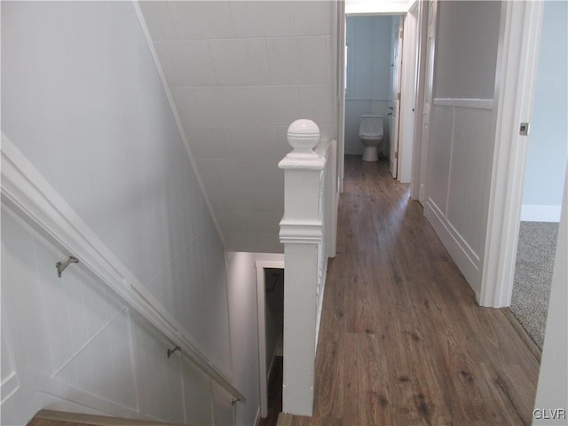 corridor with tile walls and wood finished floors