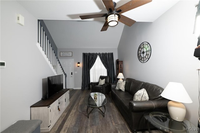 living area featuring vaulted ceiling, stairway, ceiling fan, and dark wood-style flooring