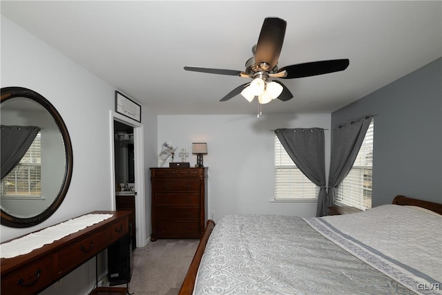 bedroom with a ceiling fan and carpet