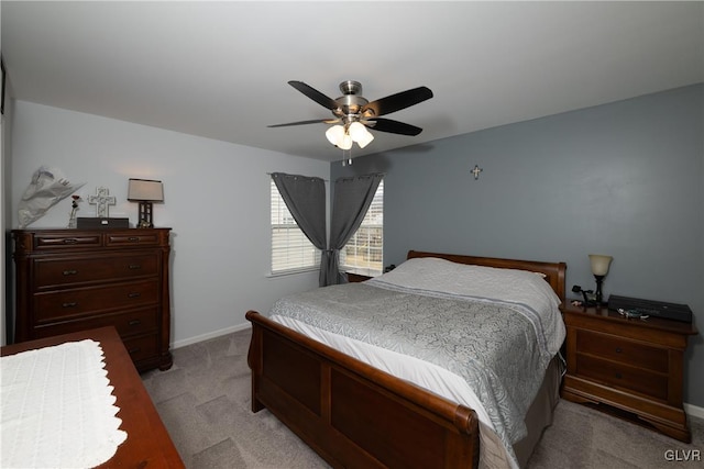 bedroom with light colored carpet, baseboards, and ceiling fan