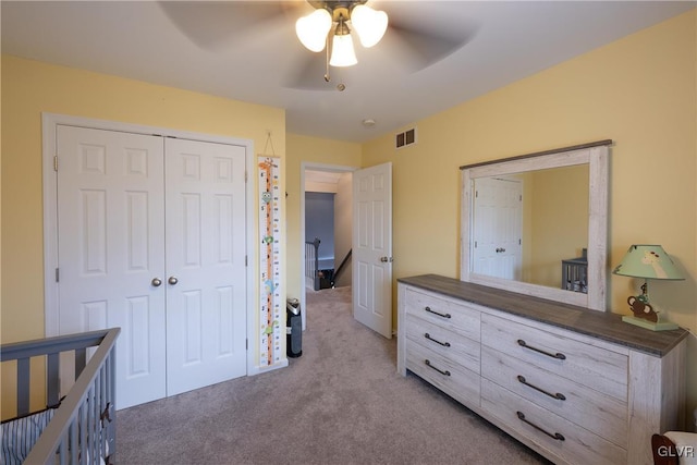 bedroom featuring a closet, visible vents, ceiling fan, and carpet floors