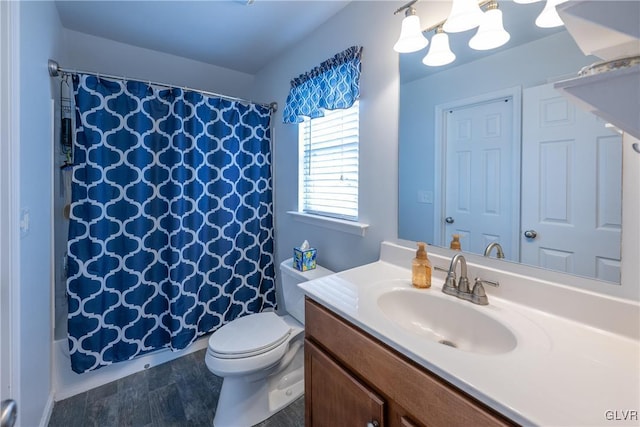 bathroom featuring vanity, toilet, and a shower with curtain